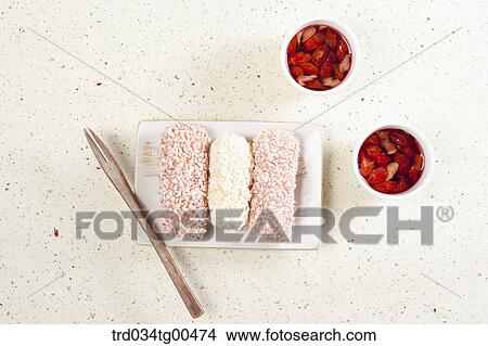 Picture - Cups of date tea and a plate of Korean traiditional sweets. Fotosearch