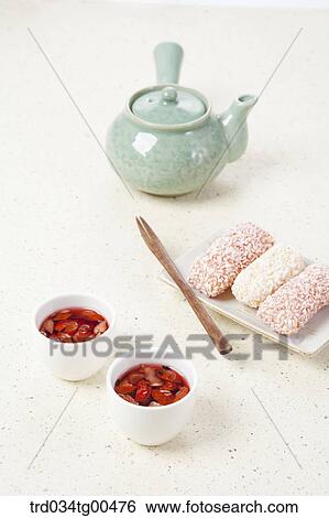 Stock Photograph - Cups of date tea and a plate of Korean traiditional sweets. Fotosearch