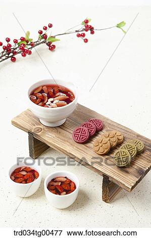 Stock Photo - Cups of date tea and Korean traiditional sweets. Fotosearch