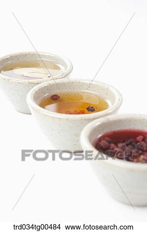 Picture - Cups of various tea with fruits and leaves. Fotosearch