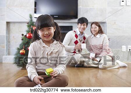 Picture - Happy family and a christmas tree. Fotosearch