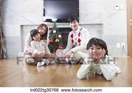 Happy family and a christmas tree View Large Photo Image Stock Photo - Happy family and a christmas tree. Fotosearch