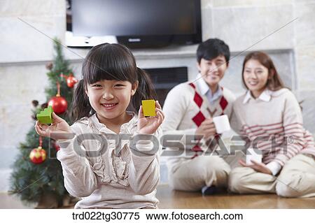 Happy family and a christmas tree View Large Photo Image Stock Photography - Happy family and a christmas tree. Fotosearch