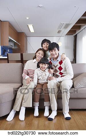 Stock Image - Happy family on the sofa. Fotosearch