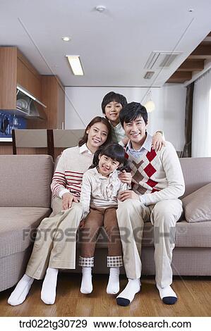 Happy family on the sofa View Large Photo Image Stock Photo - Happy family on the sofa. Fotosearch