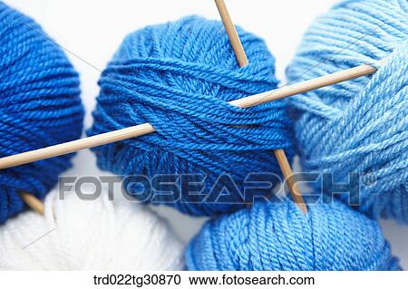 Stock Image - Knitting yarn ball sin blue tone and needles. Fotosearch