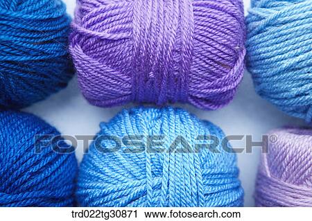 Stock Image - Knitting yarn balls in blue and purple tone. Fotosearch