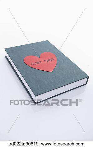 Stock Photo - MUST PASS message on the red heart paper on the book. Fotosearch