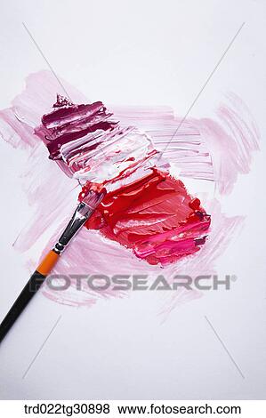 Stock Photo - Paints in red tones and a brush. Fotosearch