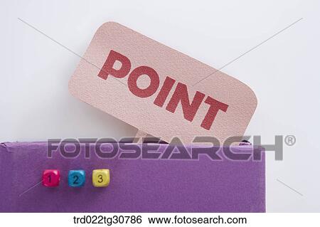Stock Photograph - POINT message on purple book and dices. Fotosearch