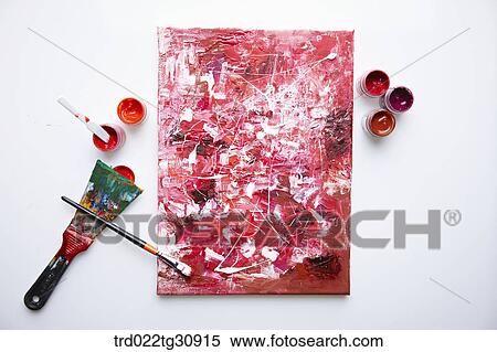 Stock Photography - Scribbles of paints on canvas in red tone. Fotosearch