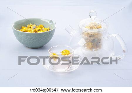 Stock Photo - Tea pot and a cup of dandelion tea and its dried flowers. Fotosearch
