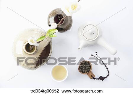 Stock Image - Tea pot and a cup of green tea. Fotosearch