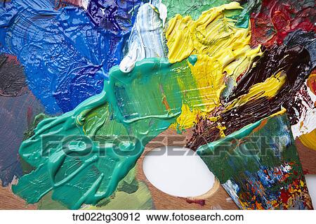 Stock Image - Various color paints on a wooden palette. Fotosearch