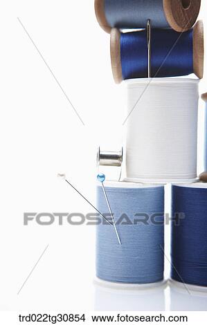 Picture - Various reel of threads and sewing tools in blue. Fotosearch