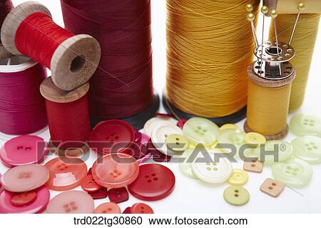 Various reel of threads and sewing tools in red and yellow View Large Photo Image Stock Image - Various reel of threads and sewing tools in red and yellow. Fotosearch