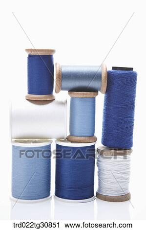 Stock Image - Various reel of threads in blue tone. Fotosearch