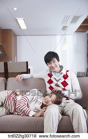 Woman resting on man's lap on the sofa View Large Photo Image Stock Photo - Woman resting on man's lap on the sofa. Fotosearch