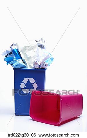 A blue trash basket full of paper trash and another red trash basket being empty View Large Photo Image Stock Photograph - A blue trash basket full of paper trash and another red trash basket being empty . Fotosearch