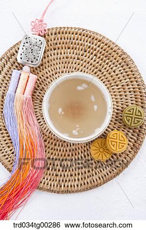 A cup of drink, colorful dessert, and traditional clothes accessory View Large Photo Image Stock Photograph - A cup of drink, colorful dessert, and traditional clothes accessory . Fotosearch