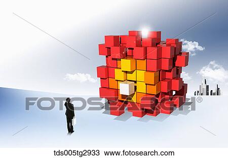 A man looking at piled yellow and red boxes View Large Photo Image Stock Image - A man looking at piled yellow and red boxes. Fotosearch