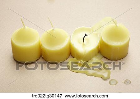 Stock Photo - A normal red lipstick and another melted red lipstick. Fotosearch