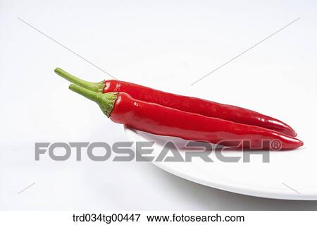 Stock Photo - A Plate Of Two Red Peppers. Fotosearch