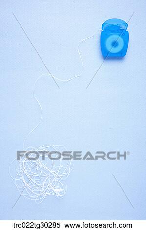 Stock Photography - A tangled blue dental floss. Fotosearch