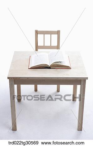 An Open Ook On Wooden Desk And Chair View Large Photo Image Stock Photo - An Open Ook On Wooden Desk And Chair. Fotosearch