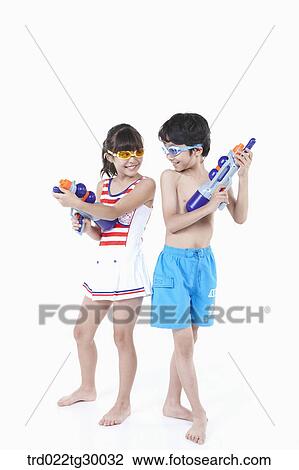 boy and girl are facing each other with water guns View Large Photo Image Stock Image - boy and girl are facing each other with water guns. Fotosearch