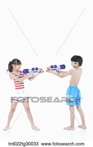 boy and girl are holding water guns on each other View Large Photo Image Stock Image - boy and girl are holding water guns on each other. Fotosearch