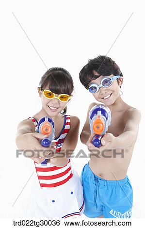 boy and girl are holding water guns on ahead View Large Photo Image Stock Photograph - boy and girl are holding water guns on ahead. Fotosearch