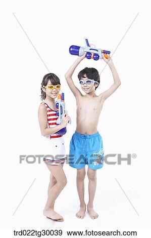 Stock Photo - boy and girl are holding water guns . Fotosearch