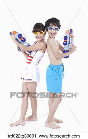 Stock Image - boy and girl are standing back to back with water guns. Fotosearch