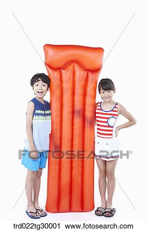 boy and girl are standing with holding bed of tube together View Large Photo Image Stock Image - boy and girl are standing with holding bed of tube together. Fotosearch