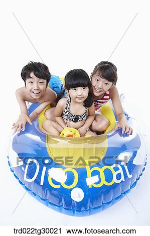 Stock Image - boy and girls are on the boat. Fotosearch