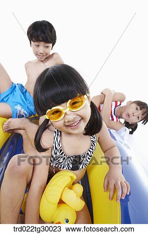 Stock Image - boy and girls are on the boat. Fotosearch