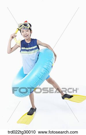Stock Image - boy is wearing snorkels and tube and flippers. Fotosearch