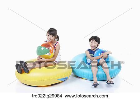 children holding beach balls and sitting on the tubes View Large Photo Image Picture - children holding beach balls and sitting on the tubes. Fotosearch