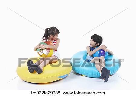 children holding beach balls and sitting on the tubes View Large Photo Image Stock Photography - children holding beach balls and sitting on the tubes. Fotosearch