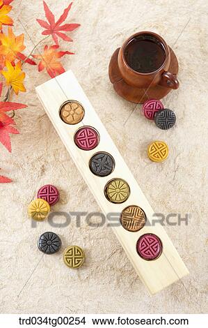 Colorful Korean dessert and a cup of tea with colored leaves View Large Photo Image Picture - Colorful Korean dessert and a cup of tea with colored leaves. Fotosearch