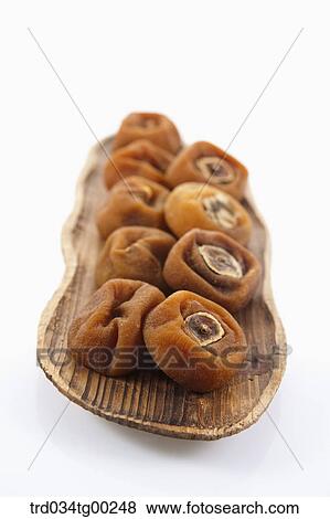 Dried persimmons on the wooden dish View Large Photo Image Stock Photo - Dried persimmons on the wooden dish. Fotosearch