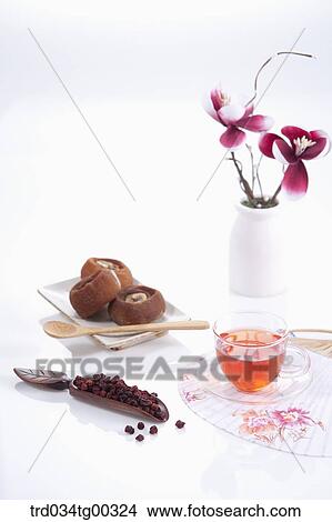 Dries persimmons and fruit, a cup of tea, a fan, and flowers View Large Photo Image Picture - Dries persimmons and fruit, a cup of tea, a fan, and flowers. Fotosearch