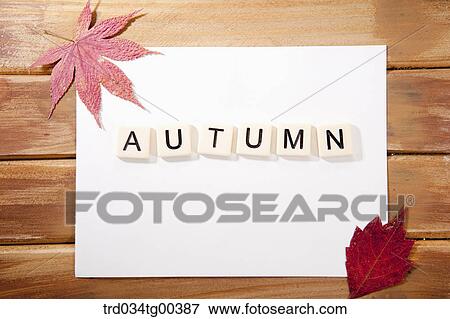 Stock Photo - Fallen Leaves And Word Autumn On White Paper. Fotosearch