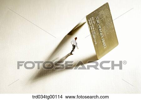 figures stood under the credit cards View Large Photo Image Picture - figures stood under the credit cards. Fotosearch
