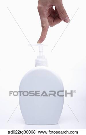 Stock Photo - finger pushes pump of liquid soap. Fotosearch