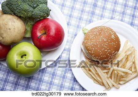 Fresh vegetable and junk food on dish View Large Photo Image Stock Photo - Fresh vegetable and junk food on dish . Fotosearch