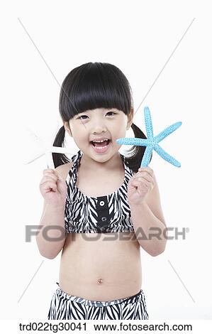 Stock Image - girl is holding starfish . Fotosearch