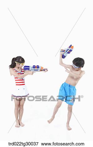 girl is holding water gun on boy View Large Photo Image Stock Photo - girl is holding water gun on boy. Fotosearch