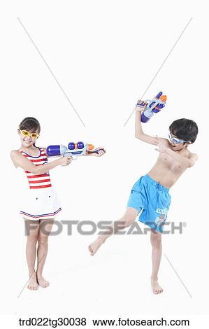 girl is holding water gun on boy View Large Photo Image Stock Photo - girl is holding water gun on boy. Fotosearch
